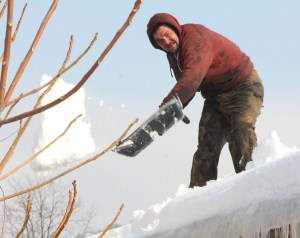 Chris Fetter works to remove heavy snow and ice off the roof of the 2nd Hand Treasure's Thrift Store in Tamaqua.