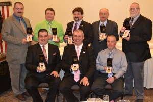 Receiving the Medal of Valor, from front left are, firefighters Donald Leshko, Daniel Leshko, and Vincent Chitswara. Receiving the Medal of Courage, from back left, are firefighters Robert Leshko, Leon Sobowleski Jr., Lance Borchick, Matt Capulich, and John Mears Sr.