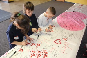 Pictured signing an American Heart Association banner are, from left, Samantha Plasha, 7; Jacob Belzner, 8; and Matthew Grasso, 7. They teachers are Mrs. Audra Schlect and Mrs. Marta Monk.