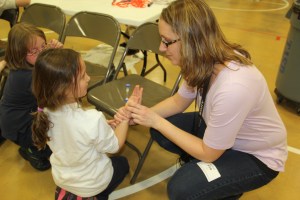 Amy Krall shows her daughter Addison, 6, how to check her pulse.