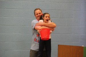 Teacher Tim Gombar shares the slime with student Grace Kinder.