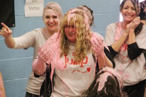 Covered in pink slime, Michele Bittner laughs with fellow teachers.