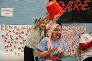 Teacher Vanessa Boyle gets slimed by student Makayla Bartenope.
