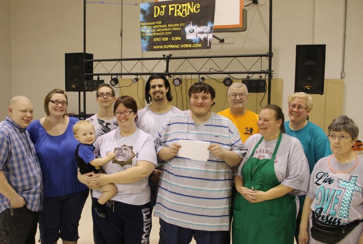 Pictured from left are volunteers Matthew Greenly, Mel Latham, Noah Griffith, Salvation Army Major Sharon Whispell holding Abraham Greenly (21-months), Charles Durning, Frank Latham, Jesse Durning, Lorraine Durning, Mary Hosler and Cathy Johnson.