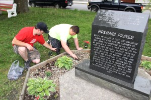 Lansford firefighters Zach Gilbert (right) and Lt. Bryn Zellner work with other firefighters and Legion members to spruce up areas of the park in preparation for Monday's Memorial Day Service.