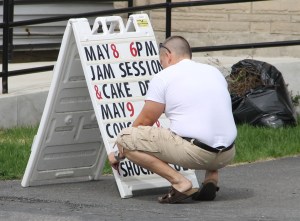 Shannon Rega Placing Sign Out Front of Community Arts Center, Tamaqua, 5-5-2014 (2)