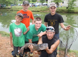 Pictured with a 9 pound 11 ounce catfish are are David Galasso, 13; Ben Vough, 11; Jon Vough 14; Devin Vough, 9; and club volunteer Tom McMann. 