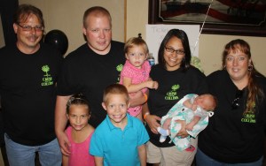 Pictured from back left are event volunteer John Kostanesky, fire victims Joe Collins, holding Rylan, 2; Stephanie Collins - holding Jaxon, 1-week old; and event volunteer April Hagans. In front are Jabyn, 7, and Logan Collins, 8.