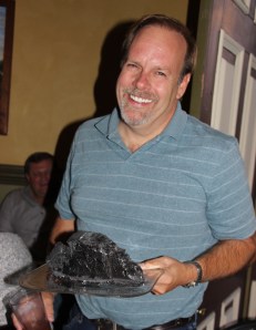 Scott Herring laughs when a friend presents him a piece of anthracite coal on a plate.