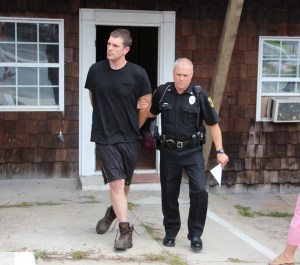 qua Police officer Rick Bekesy escorts Thomas Kehl to the police station.
