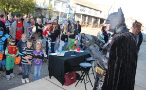 Kids listen to anti-bullying presentation by Batman during the event.