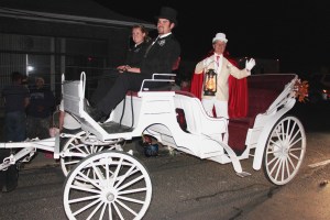 Donald Serfass served as this year's grand marshal. Also pictured are carriage operators Kyle Hoppes and Emily Mitchell. 