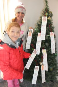 Lisa Christman and AnnMarie Skasko pick a tag off the Angel Tree at the Tamaqua Salvation Army. Both are with REDCO.