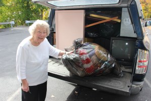 Betty Dolinksy, 86, stands next to one of four loads of donated items.