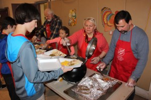Volunteers preparing meals for take-out and delivery.