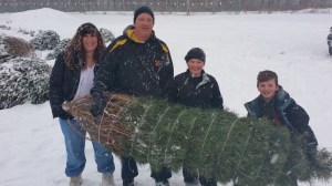 Holding their concolor fir tree are, from left, Suzanne and Jim Mayberry with kids Cambria, 10, and William, 8.