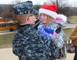 Home for the holidays, Gabe Bumberger receives a hug from his sister Alley after surprising her at school.