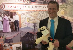Tamaqua branch manager Brian Keich holds a Wells Fargo stuffed horse to be given to the family.