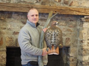 Special to TamaquaArea.com / Carver Tom Horn with red-tailed hawk carving, the last of five hand-carved raptors for the Hawk Mountain Education Building.