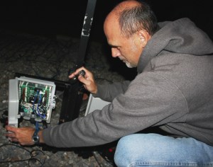 TamaquaArea.com File Photo / Frank Fabrizio works to connect thousands of lights in preparation for his season light display.