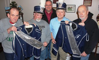 Volunteers of the Tamaqua Historical Society all former members of the Tamaqua Blue Raider Marching Band accepted a donation Thursday from the Tamaqua Area School District of two band uniforms to augment the society collection. From left, Gary Willing, Dave Weston, President Dale Freudenberger, Don Serfass and Walter Weston.