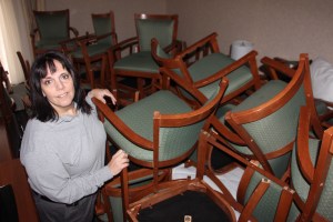 Jeaninne Motroni, manager, Comfort Inn, Hazleton, stands next to some of about 120 used chairs they donated. 