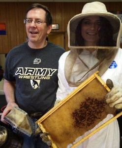 Pictured are bee keeper Dr. Joseph Hedash showing Alyssa Tirpak how to wear a bee suit.