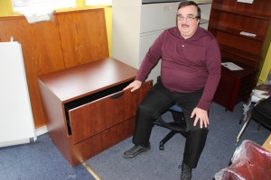 Wayne Klingaman sits next to a quality filing cabinet his store will donate and deliver to the Tamaqua Community Arts Center.