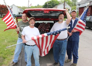 Pictured placing flags on poles along Bull Run Street are, from left, Coaldale American Legion members and volunteers John Rosahack (1st Vice), Tom Keerans Sr. (President, Coaldale Borough Council), Jimmy Rickert (Commander), and Paul Macenka (member).