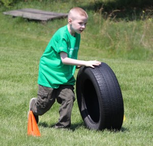 Nathan Melnick rolls a tire during one of the team challenges.