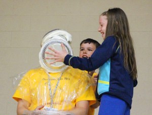 2nd grade teacher Alexa Jones receives a double pie to the face by students Michael Rascavage and Grace Stegemerten.