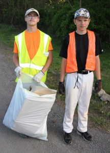 Scouts John Schroeder, left, and Ford Bradbury bring up the end during the cleanup.