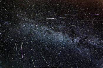 Astronomer Fred Bruenjes recorded a series of many 30 second long exposures spanning about six hours on the night of Aug. 11 and early morning of Aug. 12, 2004 using a wide angle lens. Combining those frames which captured meteor flashes, he produced this dramatic view of the Perseids of summer. There are 51 Perseid meteors in the composite image, including one seen nearly head-on. Photo credit: Fred Bruenjes