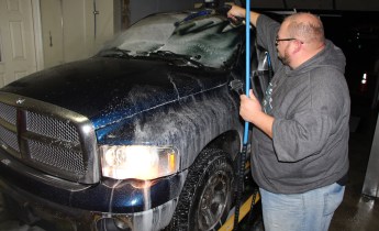 Todd Harper of The Washery Carwash washes a veteran's truck free of charge.