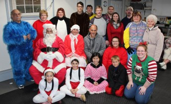 Volunteers pause for a quick photo with Mr. and Mrs. Claus.