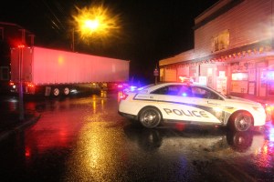 Tamaqua patrolman Tim Walsh stops Pine Street traffic as he helps a wrong-way tractor-trailer driver.